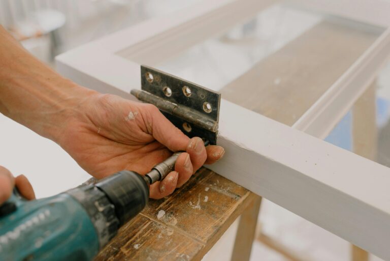 Handyman measuring and installing a fixture in Hamilton